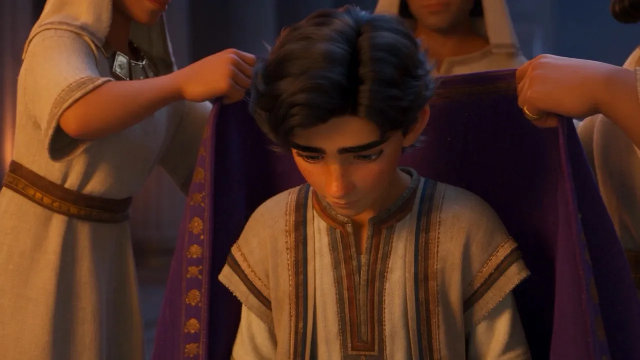 Attendants dress the bowed young man in purple