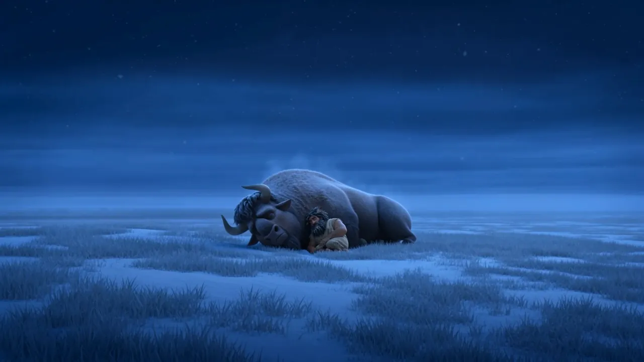At night he sleeps curled against a sleeping ox