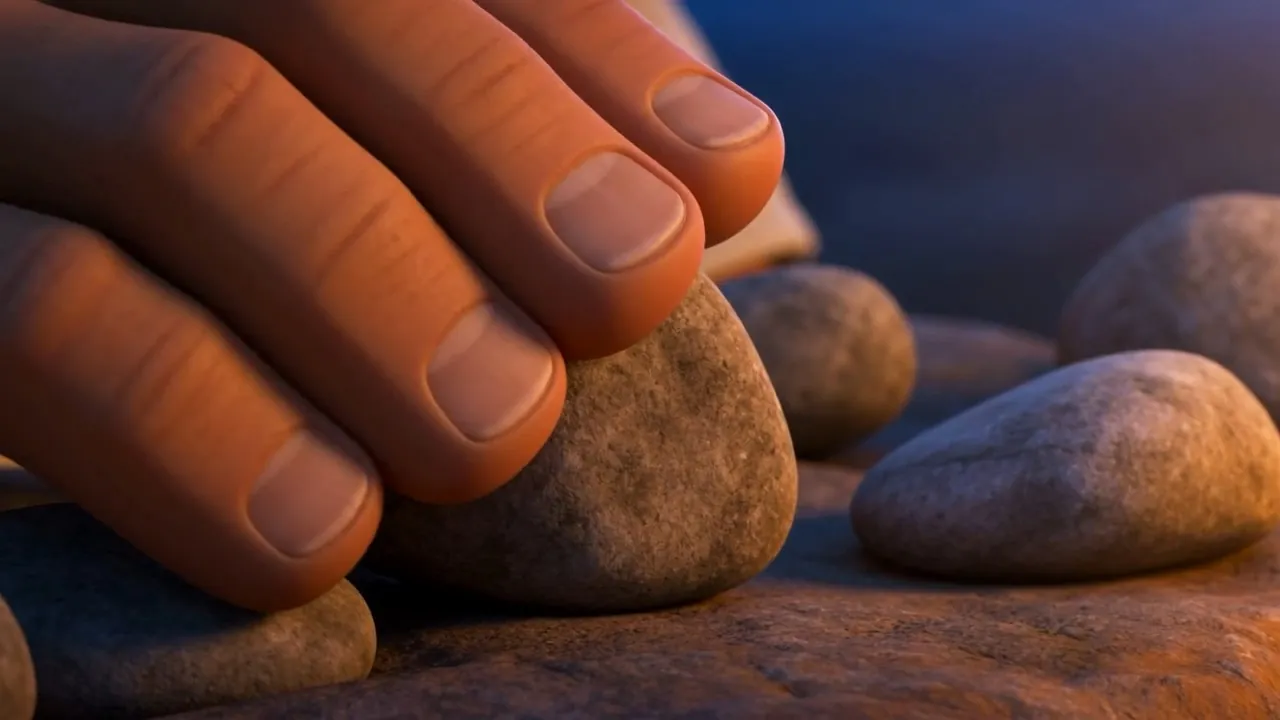 Hands setting a stone into place