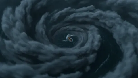 A hurricane closes its arm around one ship