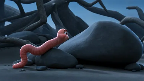 A small pink worm with a face on a rock among dead roots at dusk