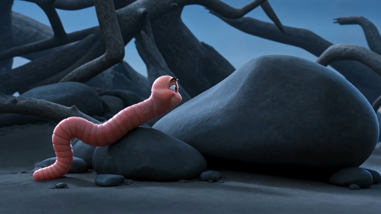 A small pink worm with a face on a rock among dead roots at dusk