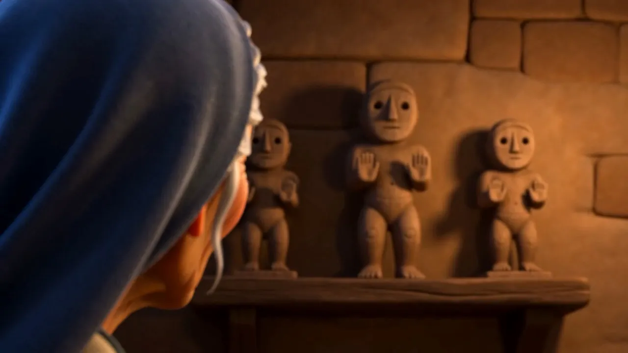 Three small carved figures on a shelf on the wall