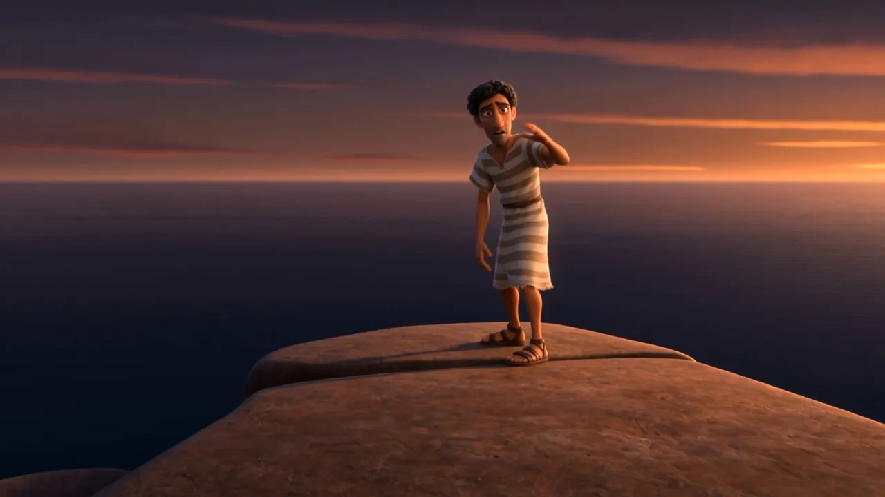 The boy stands small on the rock above a flat orange ocean