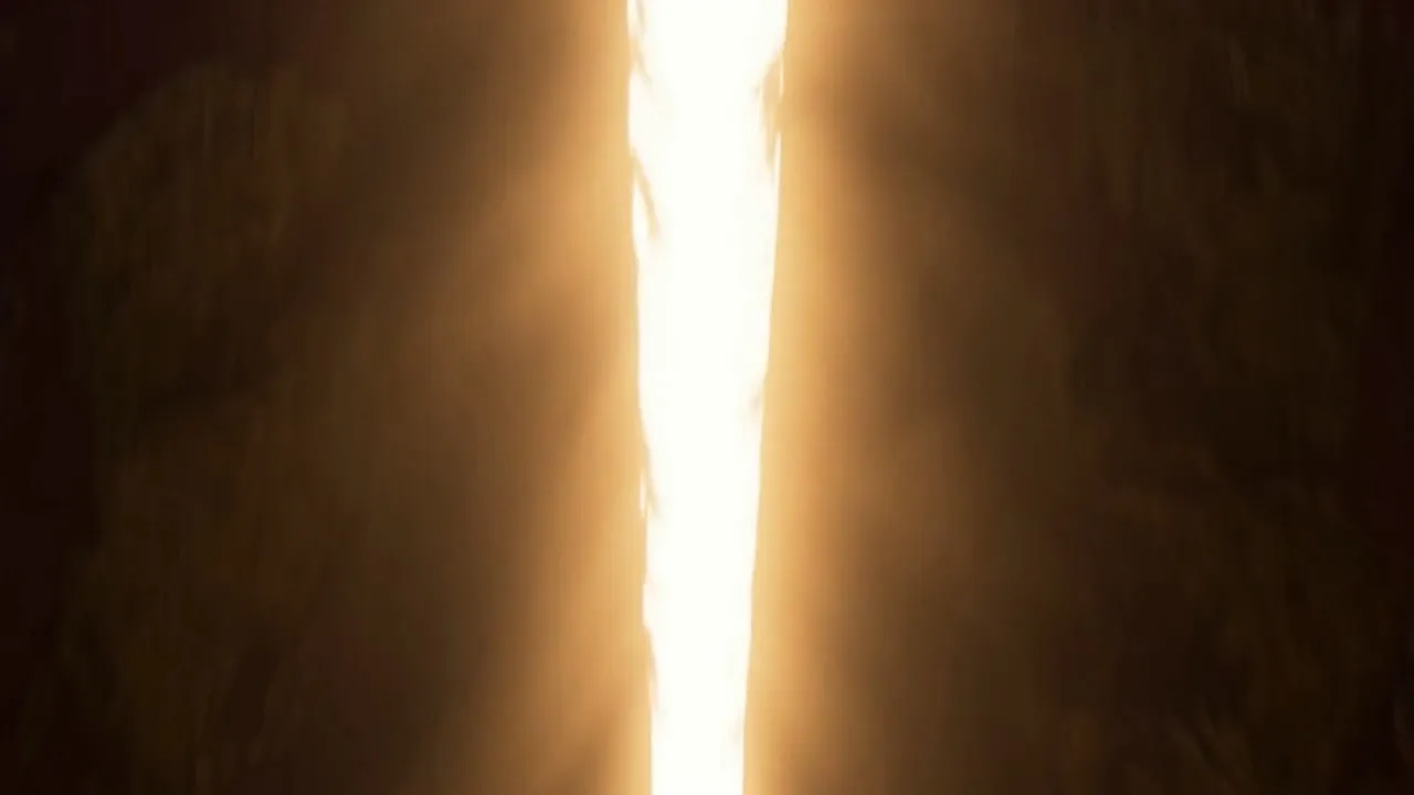 A seam of white fire opens down the middle of it